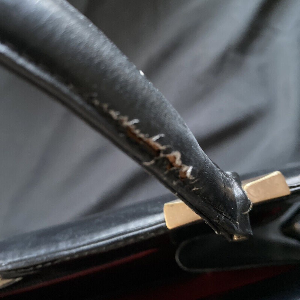 Vintage Handbag Black leather with brass fixings lined in red, heavy - (9567)