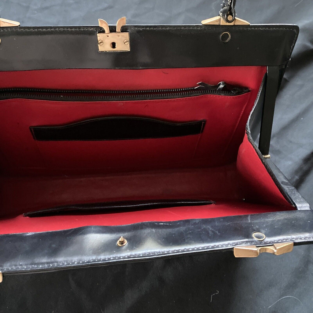 Vintage Handbag Black leather with brass fixings lined in red, heavy - (9567)