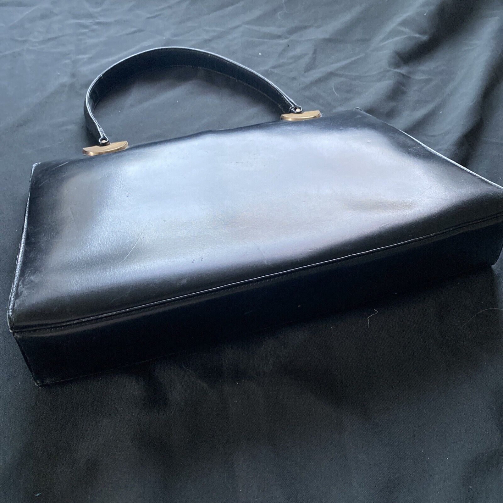 Vintage Handbag Black leather with brass fixings lined in red, heavy - (9567)