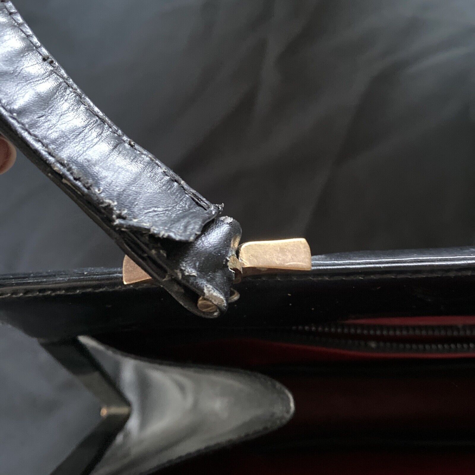 Vintage Handbag Black leather with brass fixings lined in red, heavy - (9567)