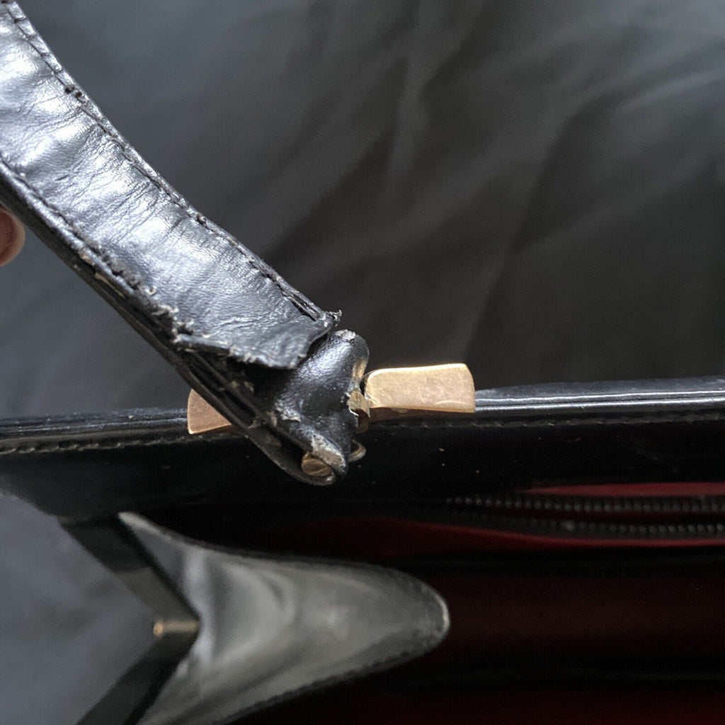 Vintage Handbag Black leather with brass fixings lined in red, heavy - (9567)